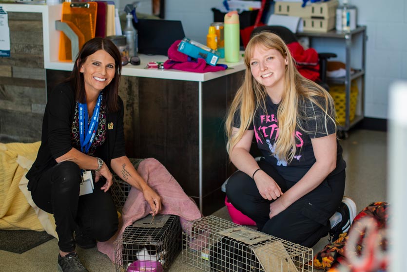VNA's Community Wellness Liaison with a Lawrence Humane Society staff member and two cats