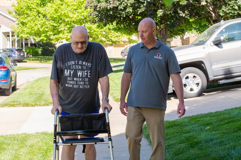 Chad, OTA, takes a short walk with Dave Aikins to assess his mobility and get him some exercise to aid his recovery.