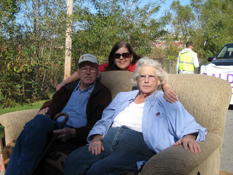 Janice poses for a picture with her parents, Richard and Beverly, on the VNA float for the Maple Leaf Parade. 