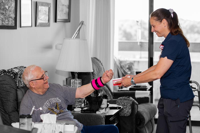 Keith Day completes an exercise with his Occupational Therapist, Kari Koester.